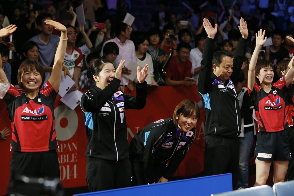 Japan's players and coach celebrate their victory over Hong Kong in the women's team semi-finals in Tokyo. Photo: EPA