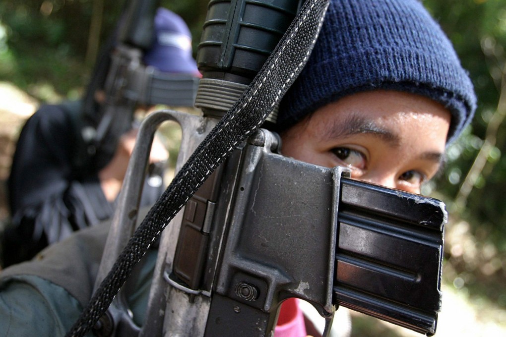 File photo of a female New Peoples Army (NPA) guerilla. Communist rebels have seized dozens of prospectors in a remote Philippine gold rush site. Photo: EPA