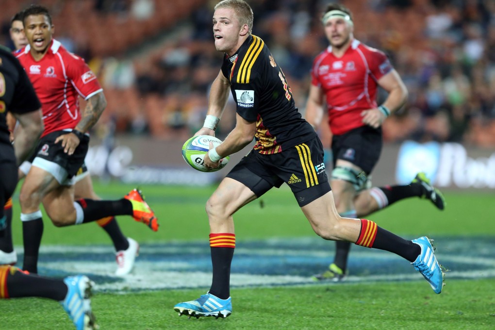 Gareth Ansombe of the Chiefs on the charge against the Lions in their Super 15 match in Hamilton. Photo: AFP