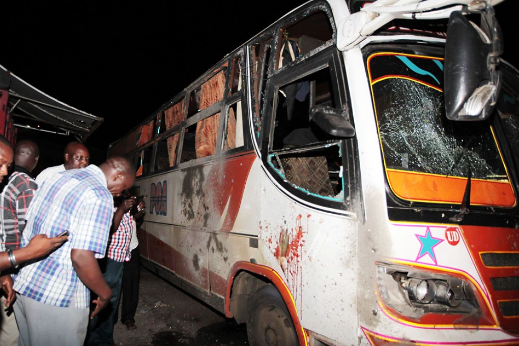 Plainclothes police check the damage to a bus at the scene of the blast at the Mwembe Tayari market in Mombasa. Photo: Reuters