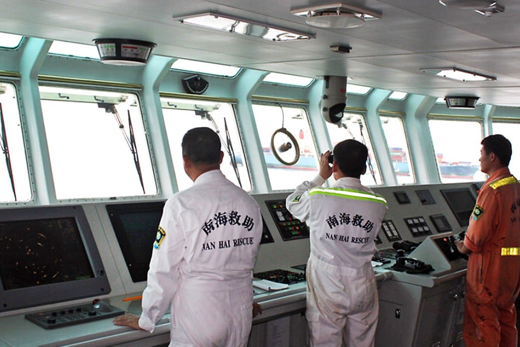 Nanhai Rescue Bureau (NRB) rescuers searching for survivors in the water after the Marshall Islands-registered MOL Motivator (in the background) collided with a Chinese cargo ship, the Zhong Xing 2, off Hong Kong waters.  Photo: AFP