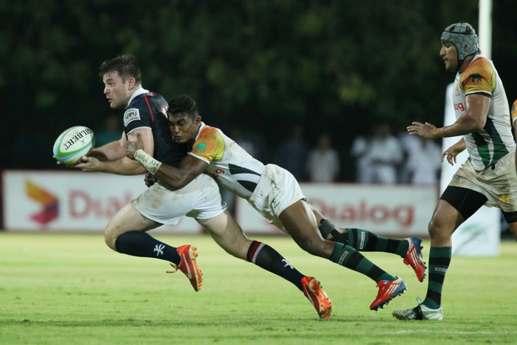 Hong Kong full-back Tom McColl looks to offload during the match against Sri Lanka. Photo: HKRFU
