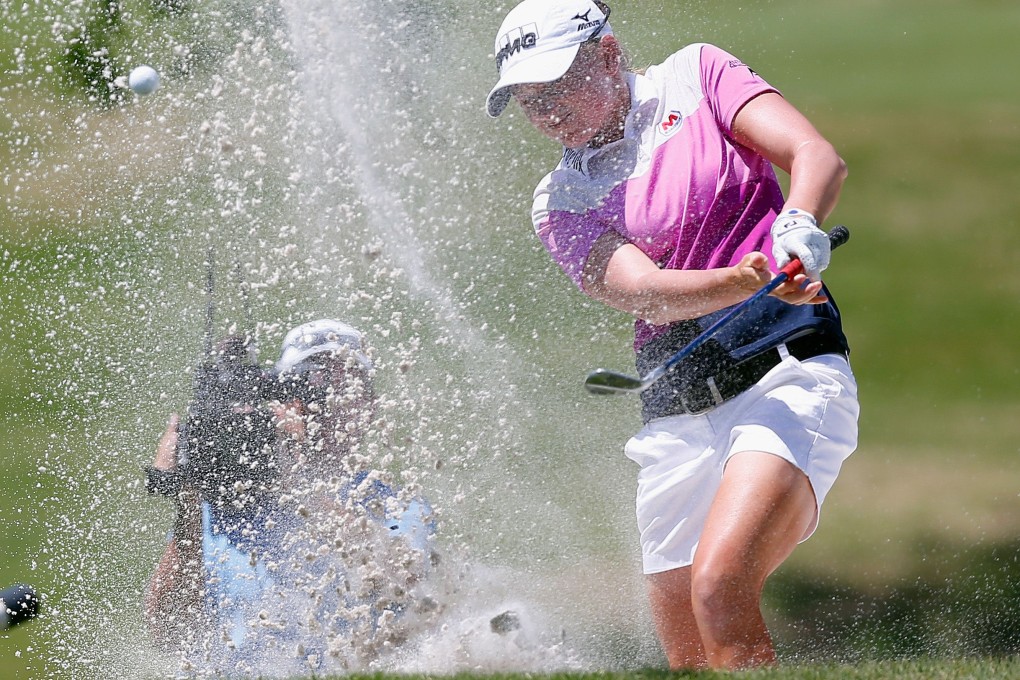 Stacy Lewis hits out of a bunker on the 11th hole during the final round of the North Texas LPGA Shootout. Photo: AFP