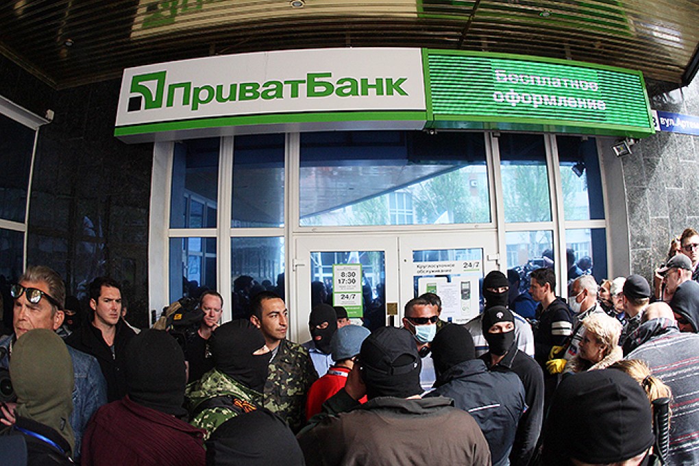 Pro-Russian militants surround a branch of Privatbank in Donetsk. Photo: AFP