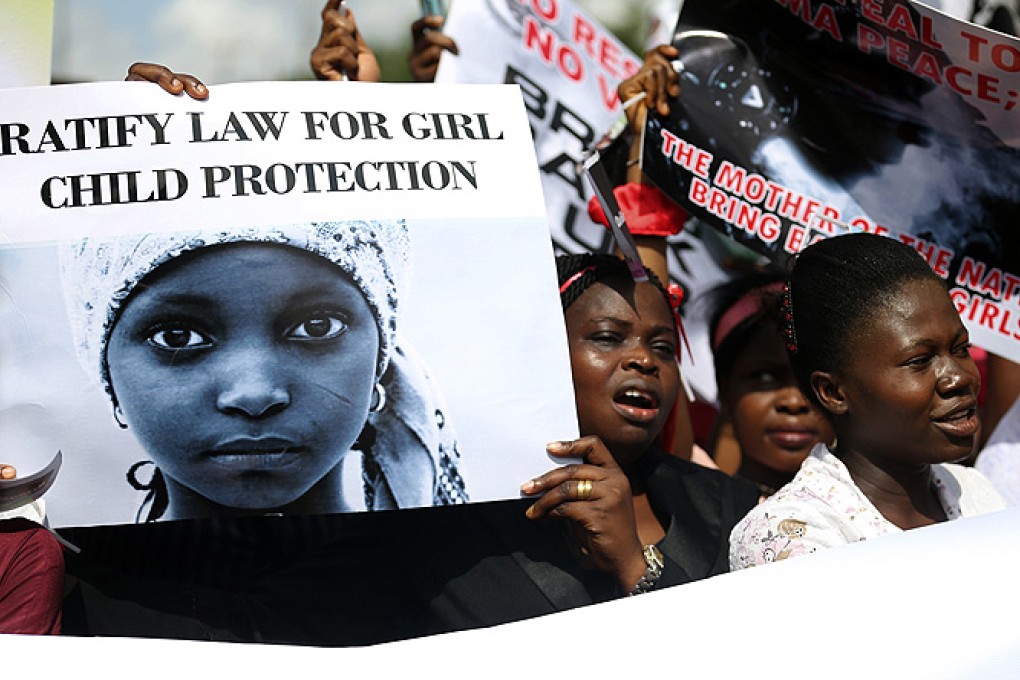 Nigerian Women holding signs take part in a protest demanding the release of abducted schoolgirls. Photo: Reuters