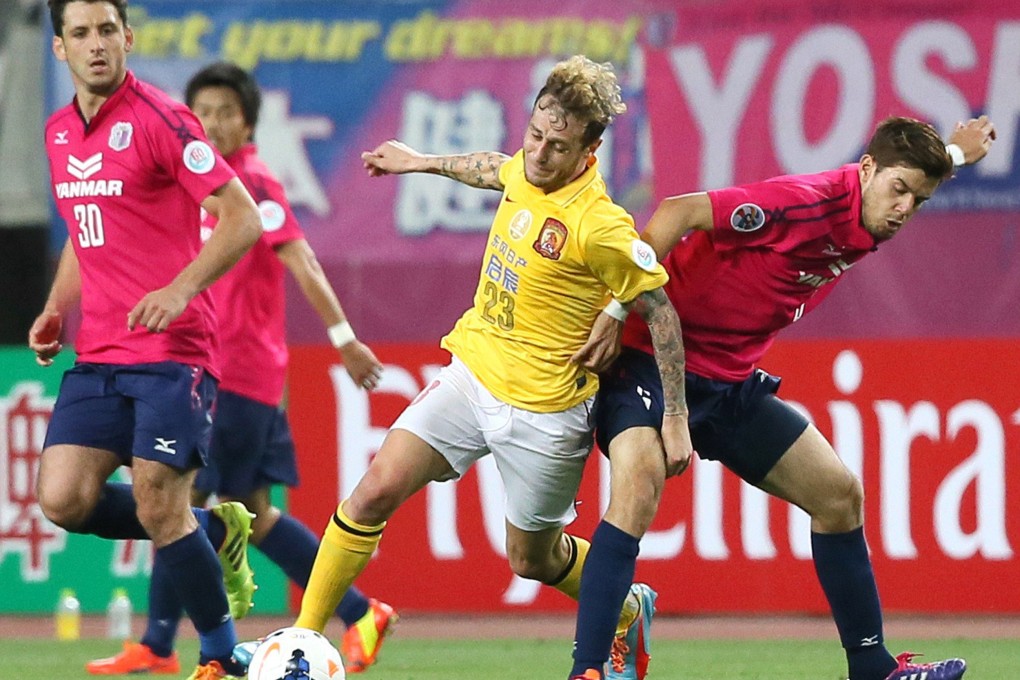 Guangzhou Evergrande's Alessandro Diamanti (centre) fights for the ball against Cerezo Osaka in their AFC Champions League first-leg round-16 match in Osaka. Evergrande won 5-1. Photo: AFP