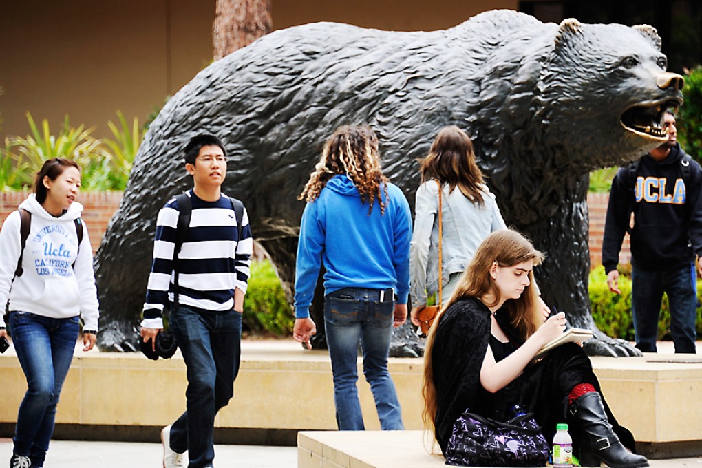 Students sit around the Bruin Bear statue on the campus of UCLA in Los Angeles, California. Photo: AFP