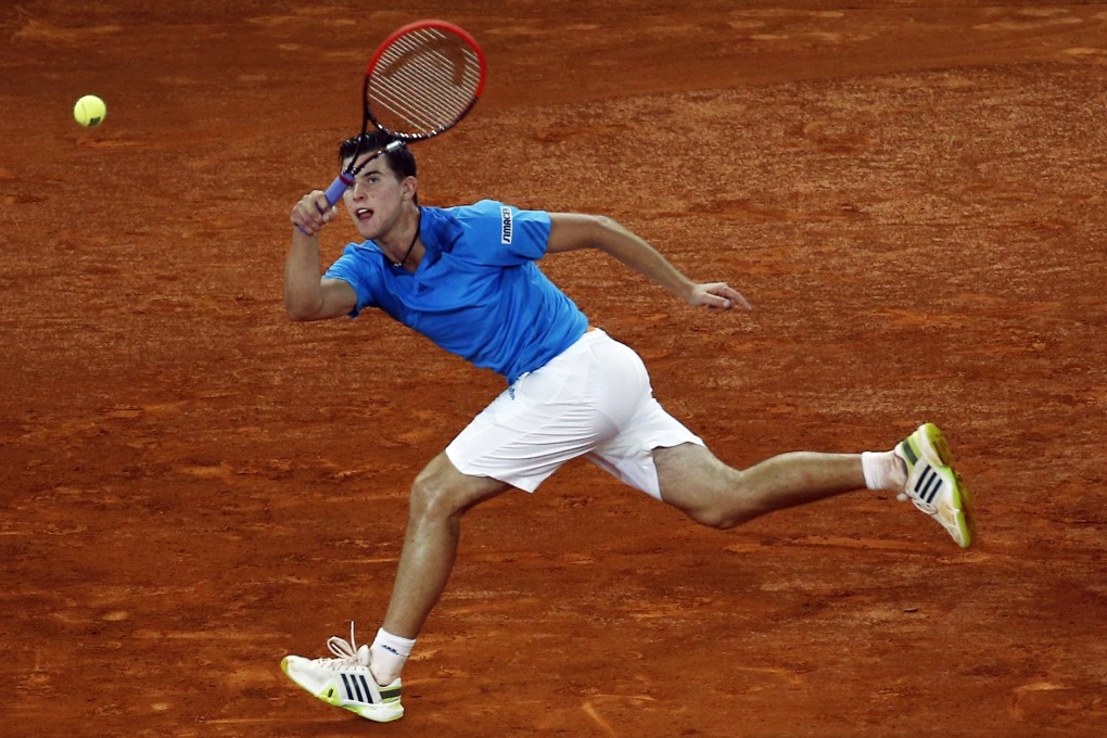 Dominic Thiem of Austria returns the ball to Stanislas Wawrinka of Switzerland during their match at the Madrid Open. Photo: Reuters