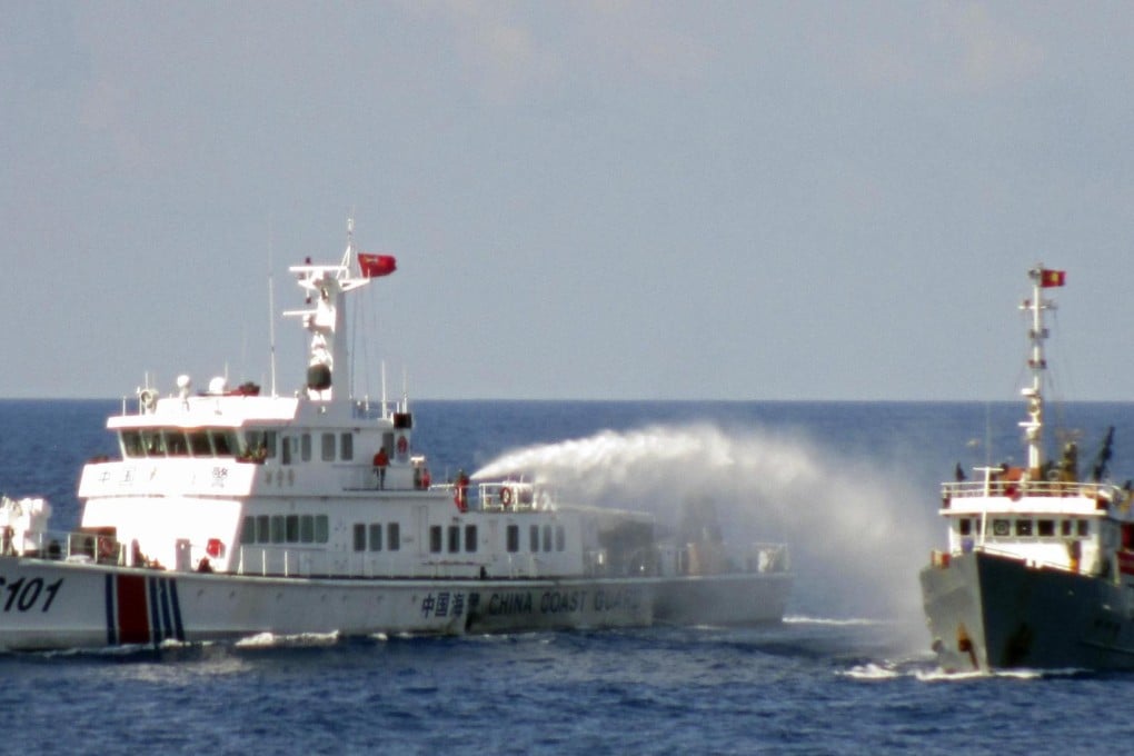 A Chinese coastguard vessel uses water cannon, apparently on a Vietnamese ship. Photo: Reuters