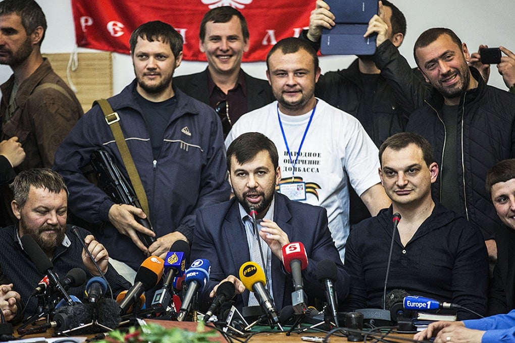 The head of the elections commission of the so-called Donetsk People's Republic, Denis Pushilin, centre, speaks at a press conference on the referendum at the occupied administration building in Donetsk. Photo: AP