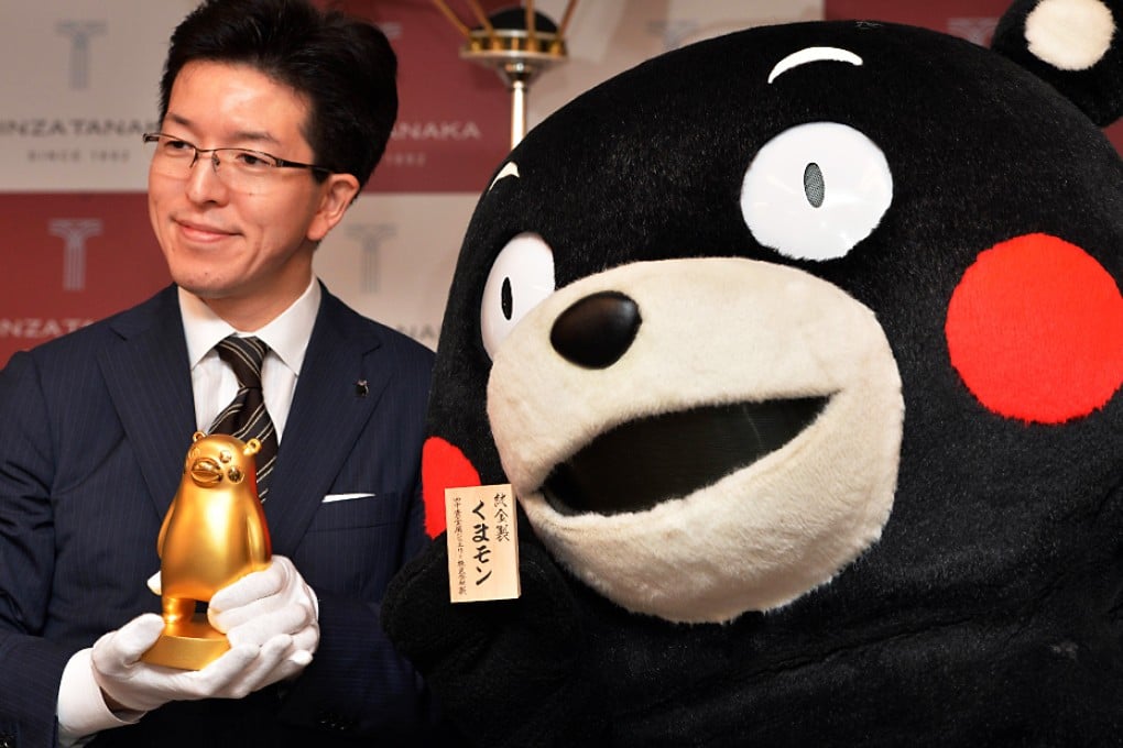 Japan's jeweler Tanaka Kikinzoku Jewelry president Masakazu Tanaka displays a pure gold Kumamon figure in Tokyo. Photo: AFP