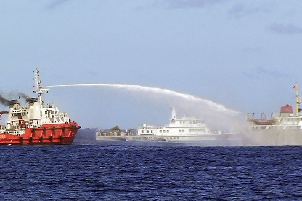 A Chinese ship (left) uses water cannon on a Vietnamese Sea Guard ship on the South China Sea near the Paracels islands. Photo: Reuters