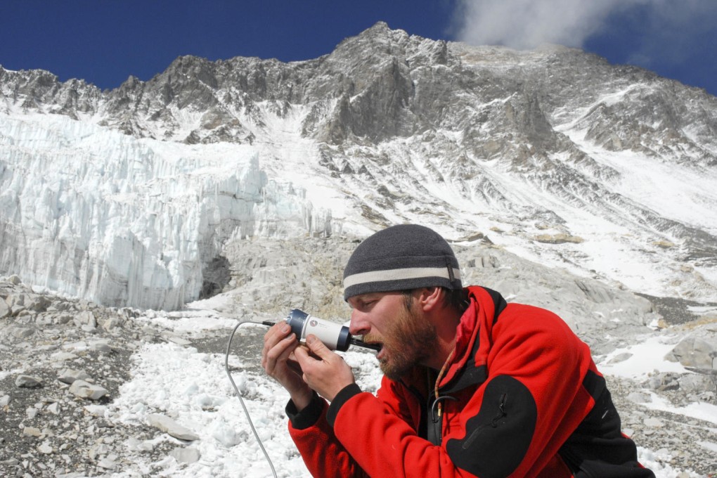 Dr Dan Martin uses an SDF camera to measure blood flow under his tongue at Everest Base Camp.