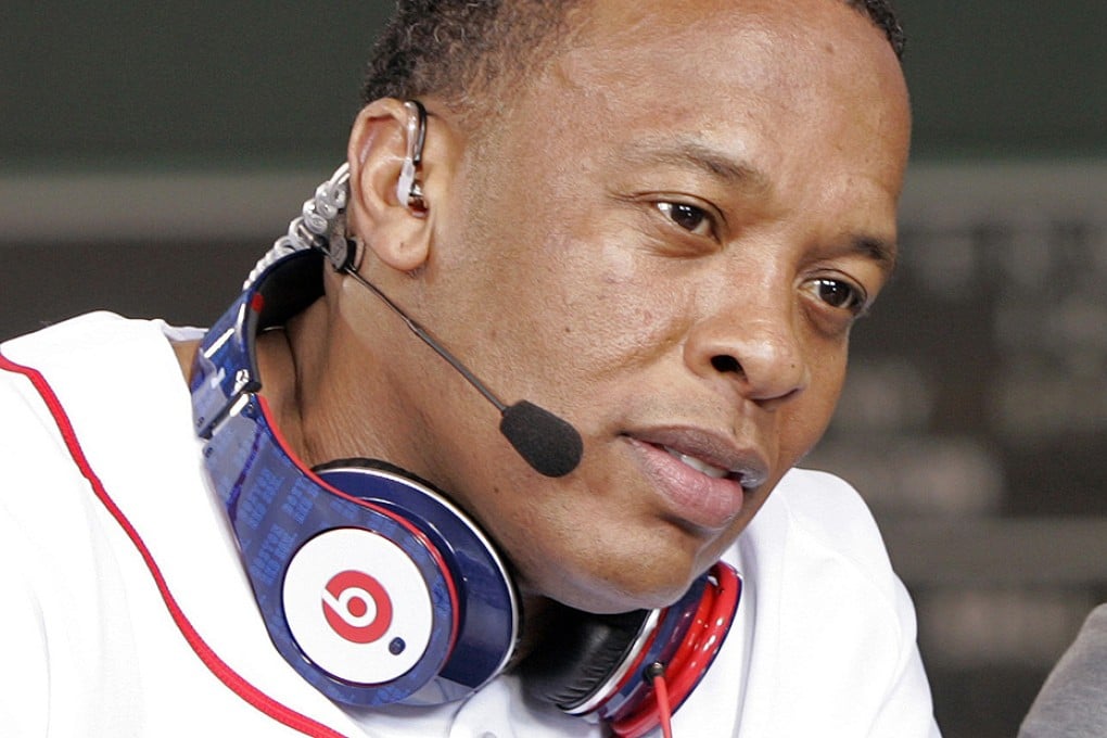 Recording artist, producer and company founder Dr Dre wears a pair of Beats headphones. Photo: Reuters