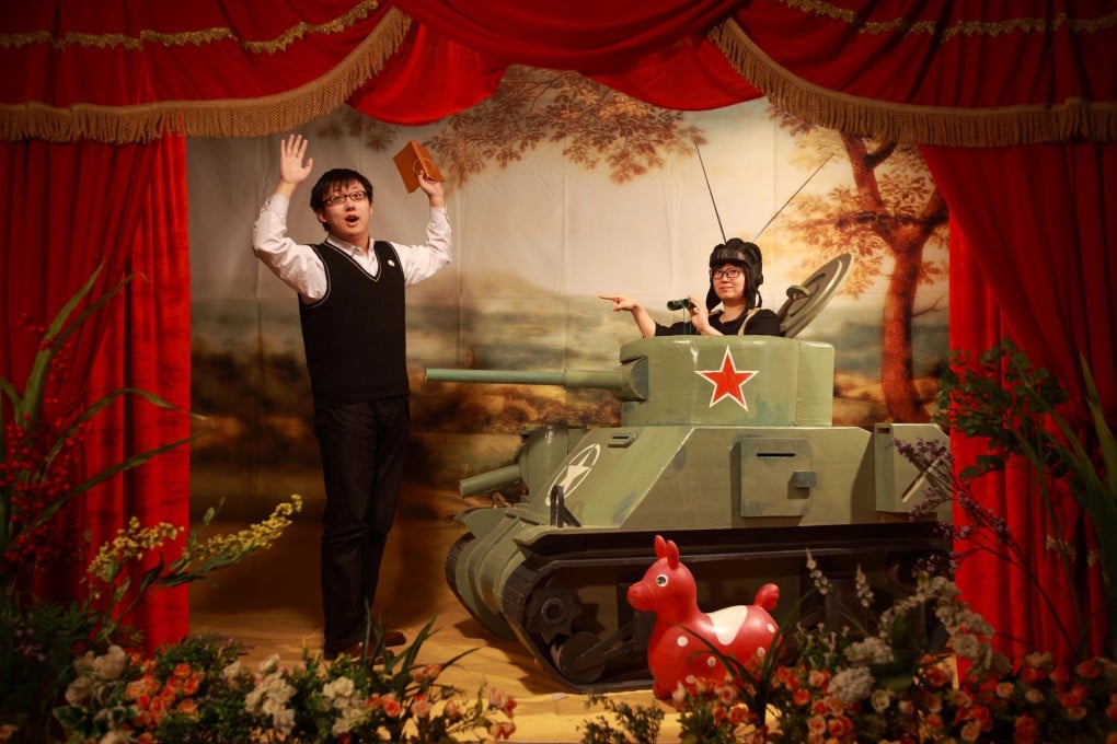 Strangers posing with theatrical props from his Studio Mobile series.