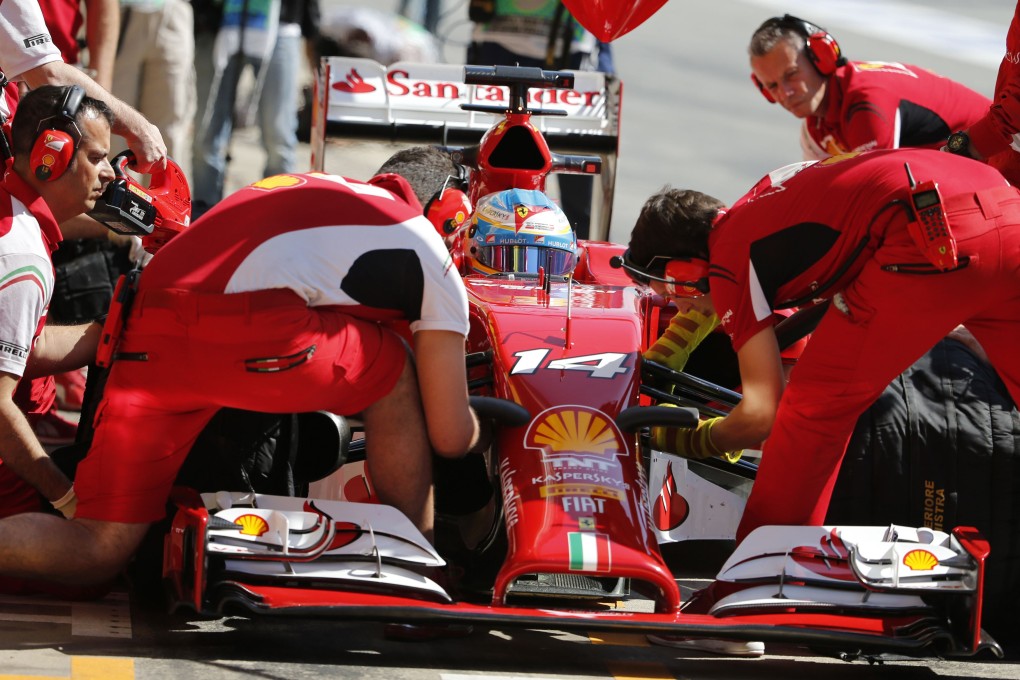 Ferrari driver Fernando Alonso of Spain performs a pit stop during the first practice session at the Circuit de Catalunya in Montmelo. Photo: Reuters