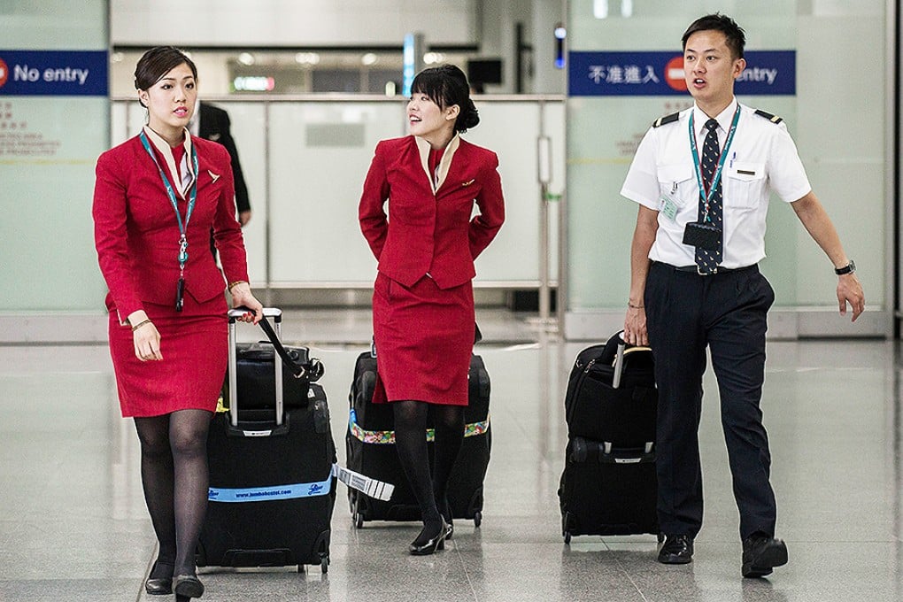 Cathay Pacific flight attendants want the airline to redesign their uniforms because they are too revealing and may provoke sexual harassment. Photo: AFP