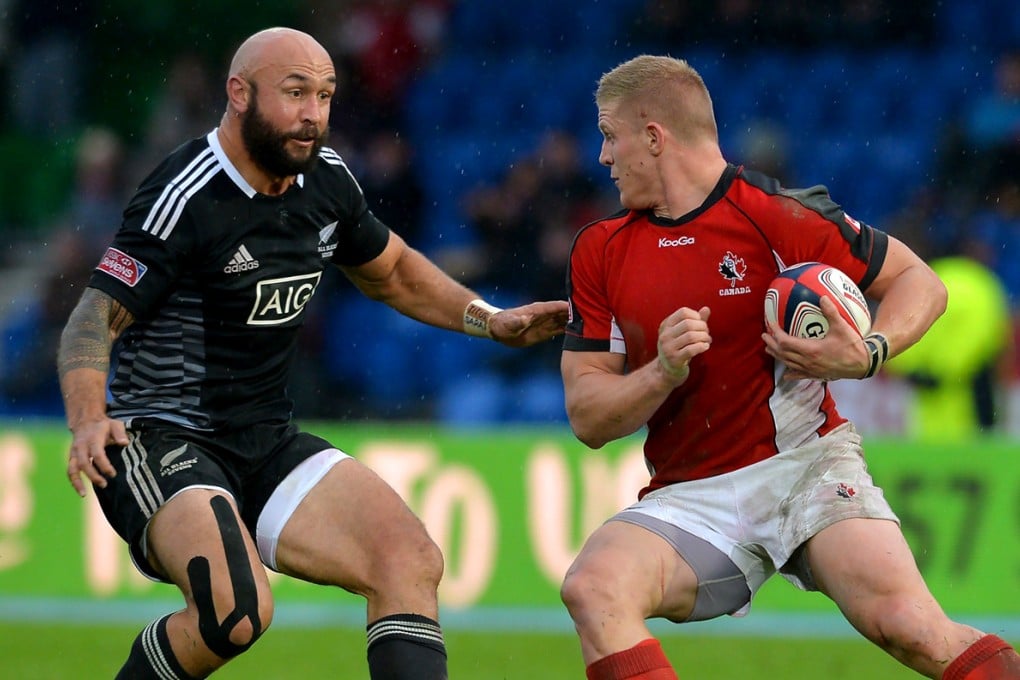 New Zealand’s DJ Forbes prepares to tackle Canada’s John Moonlight in the Scotland cup final won 54-7 by the All Blacks Sevens. Photo: IRB