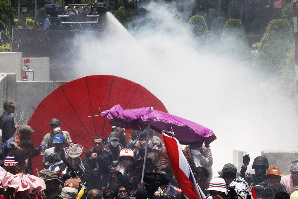 Police fire teargas and water cannon at anti-government protesters at a government security compound in Bangkok on Friday. Photo: Reuters