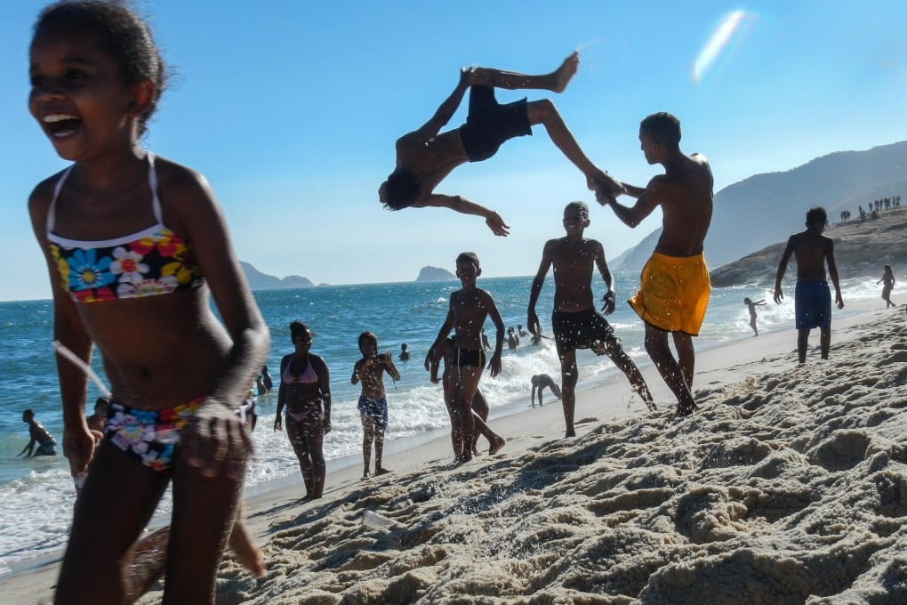 Youngsters playing at Macumba beach in Barra da Tijuca, southwestern Rio de Janeiro, Brazil. Photo: AFP/Luiz Gustavo Jnr