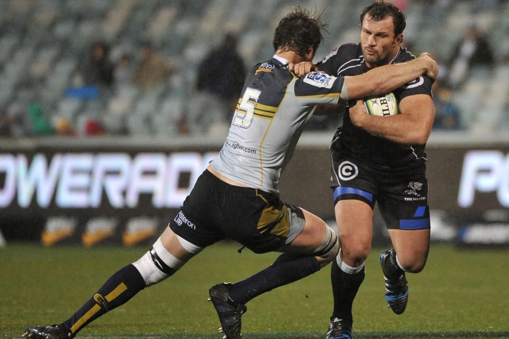 Brumbies' Sam Carter (left) takes on Sharks captain Bismarck du Plessis in their clash in Canberra. Photo: AFP