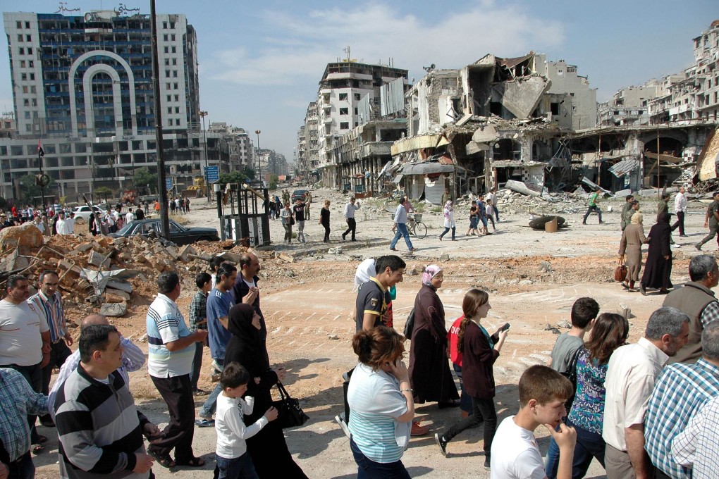 Syrians return to the Christian Hamidiyeh neighbourhood of the old town of Syria's central city of Homs after rebels left the city under an evacuation deal with the government. Photo: AFP