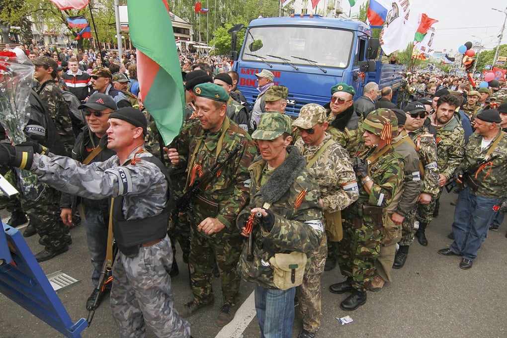 Armed supporters of the self-declared Donetsk People's Republic depart for Mariupol to help to separatists fighting Ukrainian National Guard forces. Photo: EPA