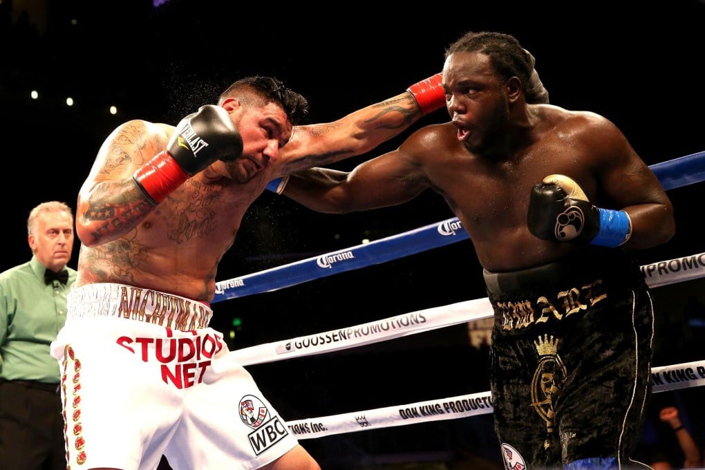 Bermane Stiverne (right) on his way to scoring a TKO win against Chris Arreola for the WBC heavyweight championship. Photo: AFP