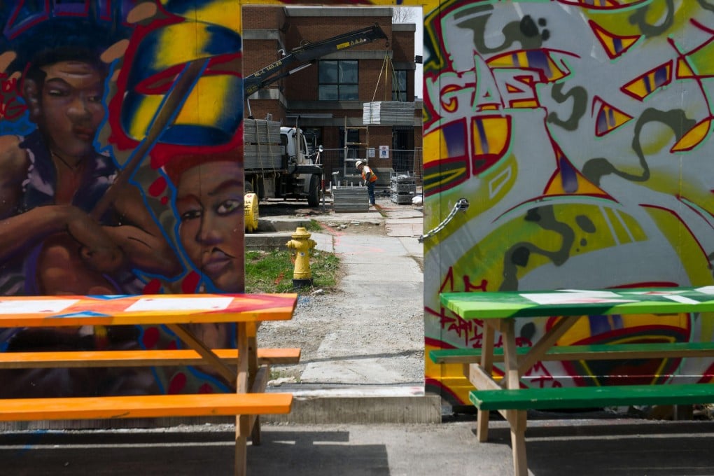 A graffiti mural decorates a wall near the Nelson Mandela Park at the crumbling Regent Park in Toronto. The estate is being transformed into North America's largest social-housing project. Photo: Bloomberg