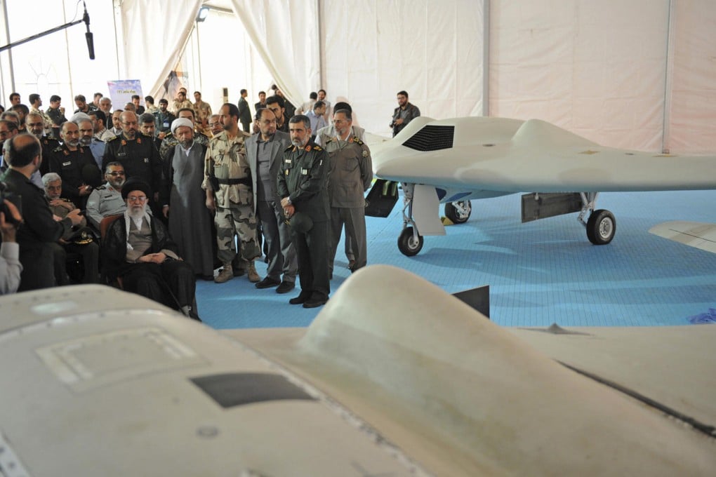 Ayatollah Ali Khamenei (seated, left) inspects drones. Photo: AP