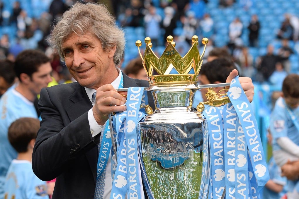 A proud Manchester City manager Manuel Pellegrini with the Premier League trophy. Photo: AFP