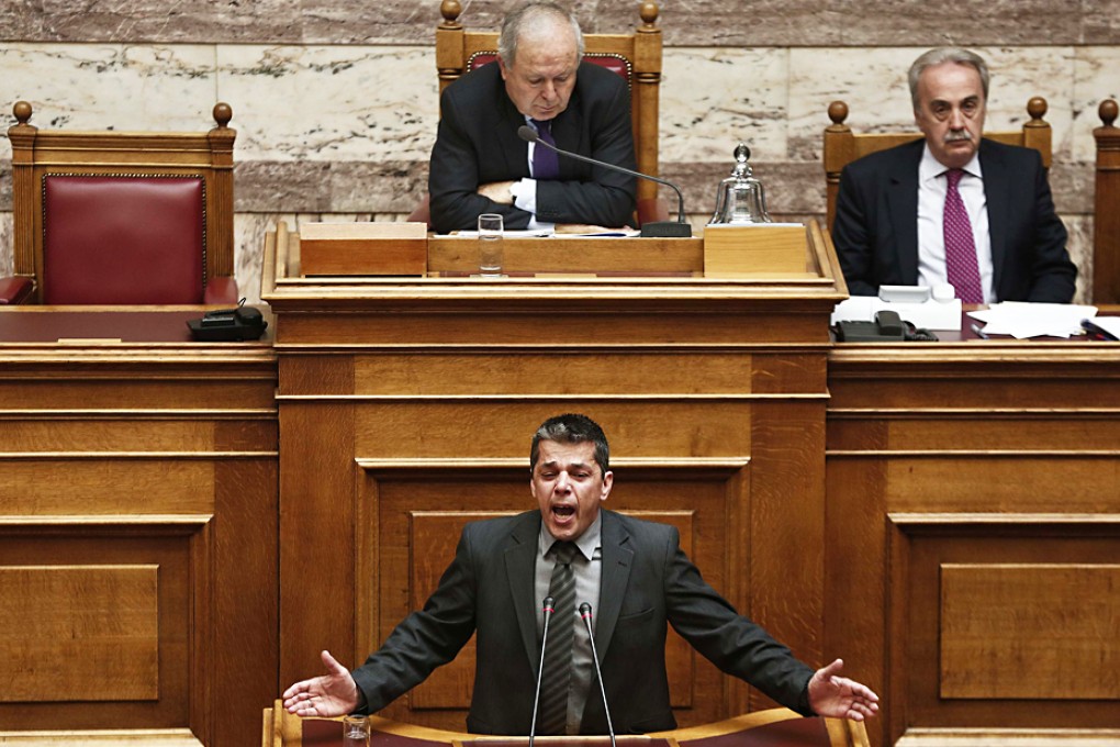 Former far-right Golden Dawn lawmaker Stathis Boukouras (bottom) shouts during his speech, before a vote for the lift of his legal immunity in the Greek parliament in Athens. Photo: Reuters