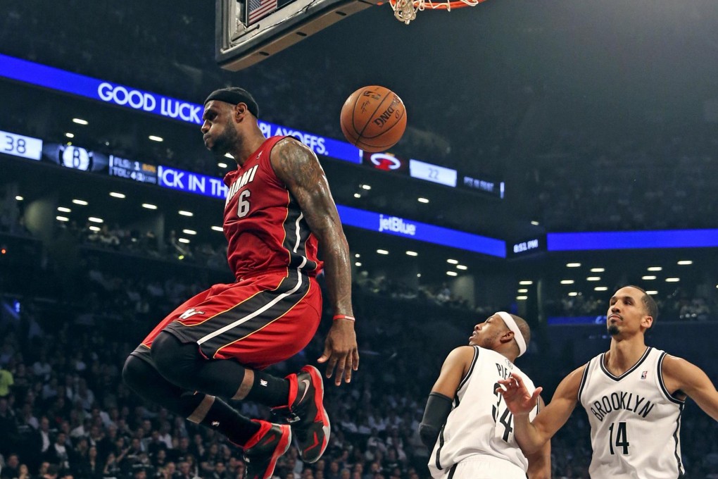 Miami Heat's LeBron James dunks the ball over Brooklyn Nets' Paul Pierce and Shaun Livingston in game four of their semi-finals. Photo: MCT