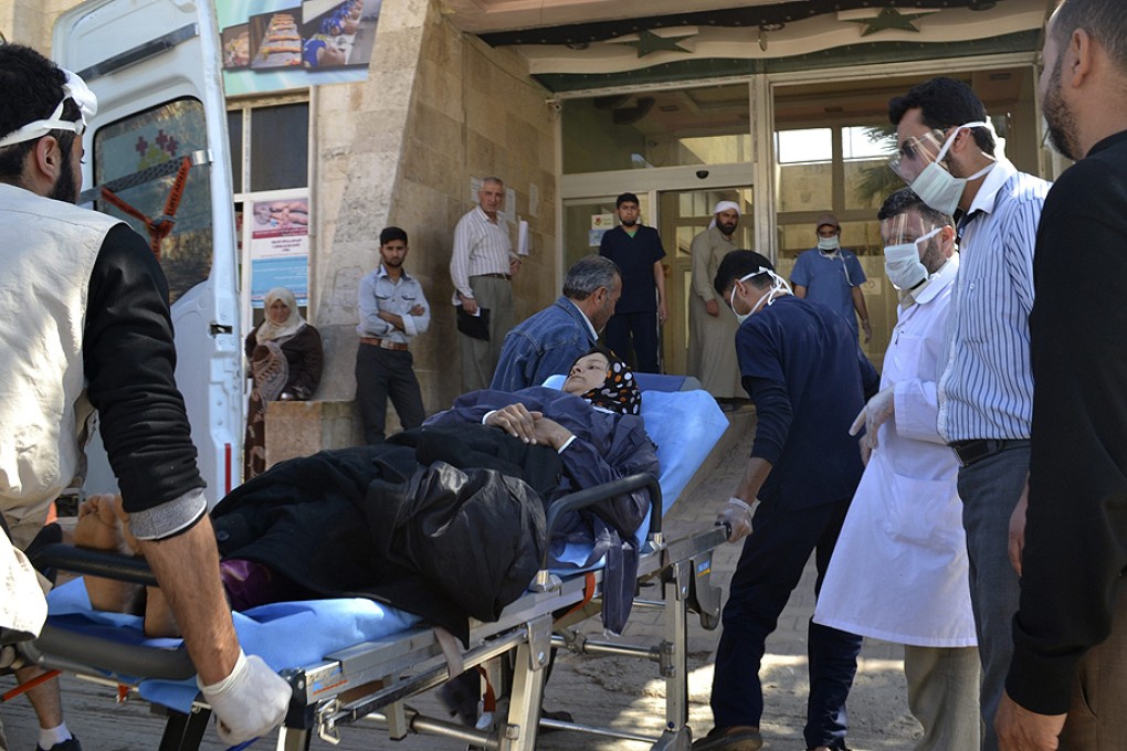 A woman affected by what activists say was a gas attack on Telmans arrives for treatment at Bab al-Hawa hospital, near the Turkish border on April 21. Photo: Reuters