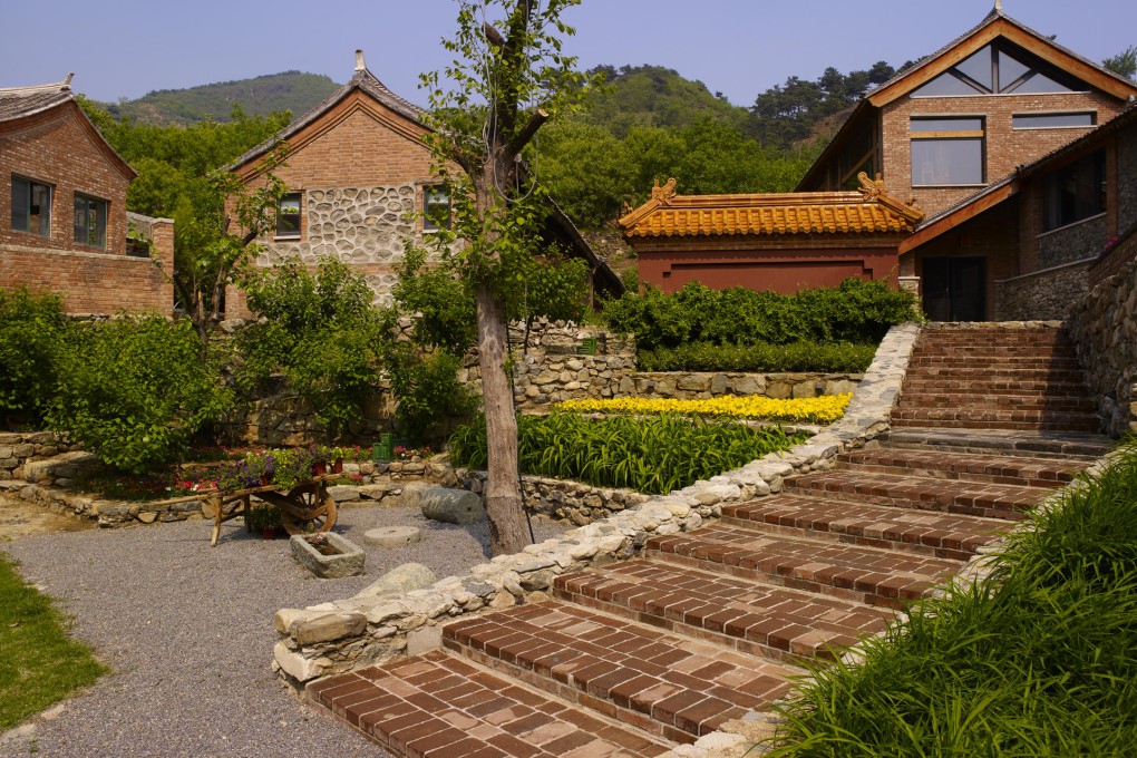 Ironstone, in Beigou village near Beijing, consists of several farmhouses and a new wing linked by an underground gallery. The 800 square metre interior features a large stone-and-granite fireplace and makes liberal use of wood to give the space visual warmth.