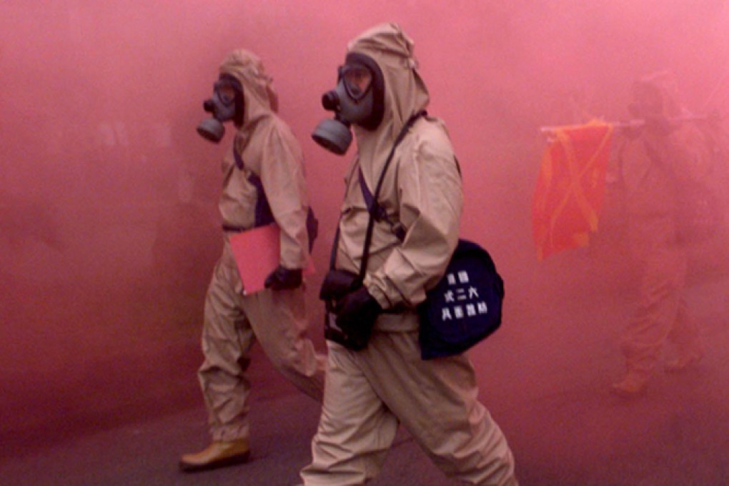 An anti-nuclear and biochemical weapons drill in Taipei uses red smoke bombs in the simulation. Photo: Reuters