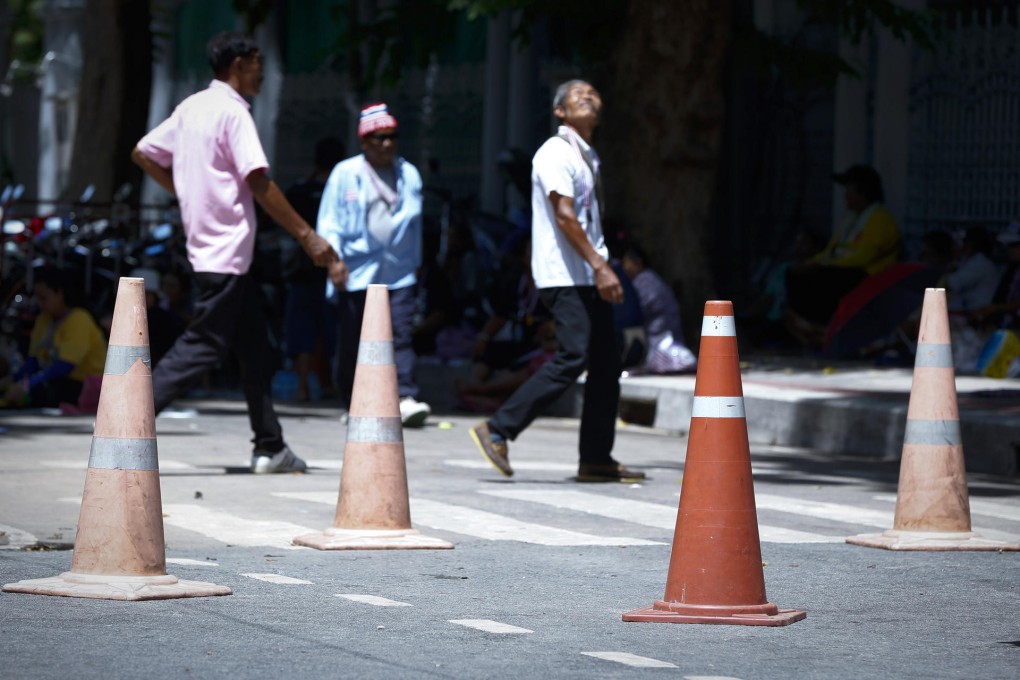 Anti-government protesters have cones in place as they wait for a rally to start outside the parliament in Bangkok yesterday. Photo: AP