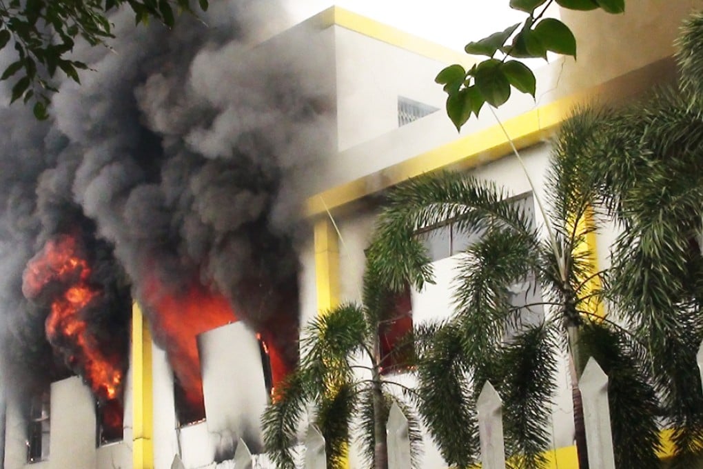 Smoke and flames billow from a burning factory. Photo: AFP