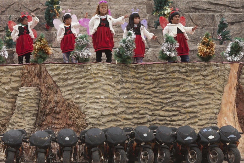 Performers including Ding Ding (far left) stage a show at the Kingdom of the Little People, in rural Yunnan province. Photos: Alex Hofford