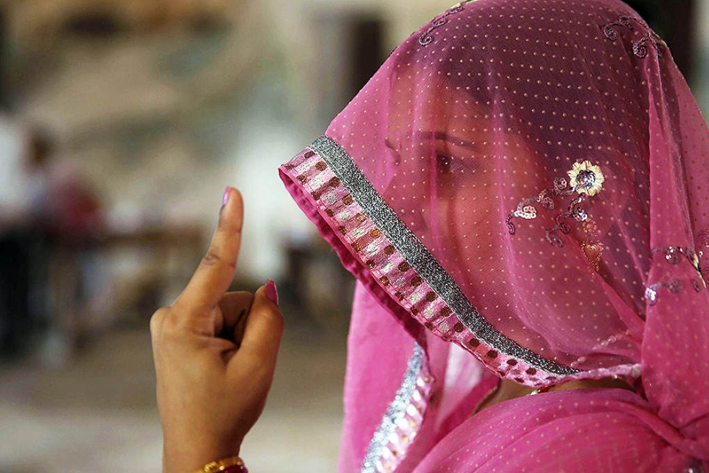 A voter in Uttar Pradesh shows her ink-stained finger. Photo: AP