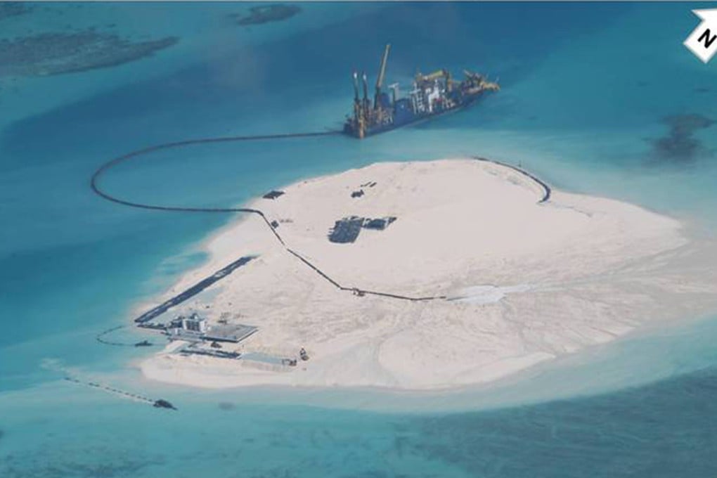 Surveillance photo by the Philippines shows a Chinese vessel, top centre, being used to expand structures and land on the Johnson Reef at the Spratly Islands at South China Sea. Photo: AP