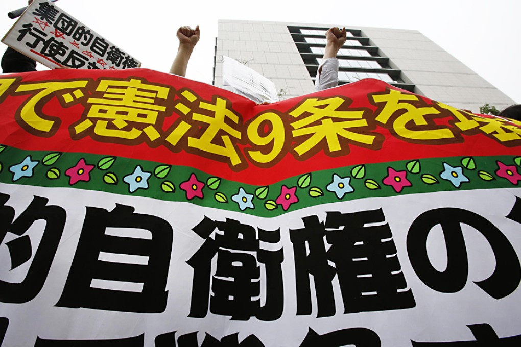 Critics of constitutional reform to expand the role of Japan's military protest in Tokyo. Photo: AP