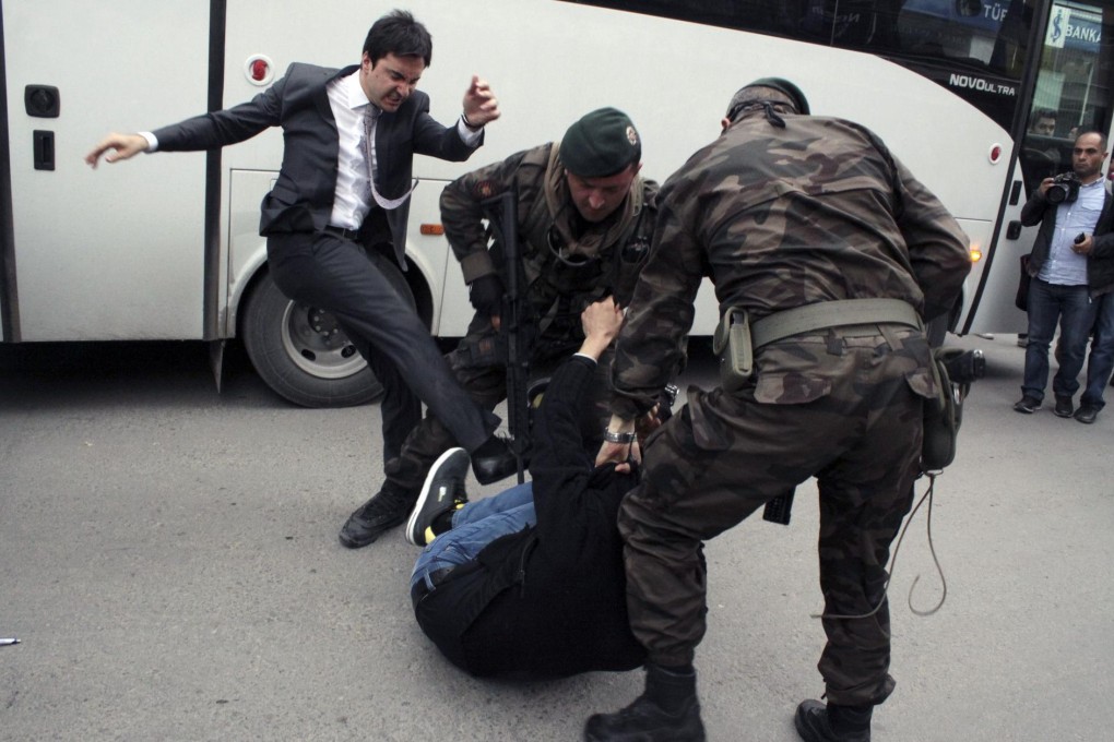 Erdogan aide Yusuf Erkel attacking a protester during the prime minister's visit to Soma. Photo: AFP