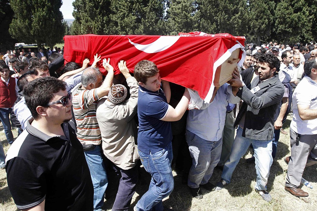 Mourners carry the coffin of a miner who died in the mine, draped with a Turkish flag. Photo: Reuters