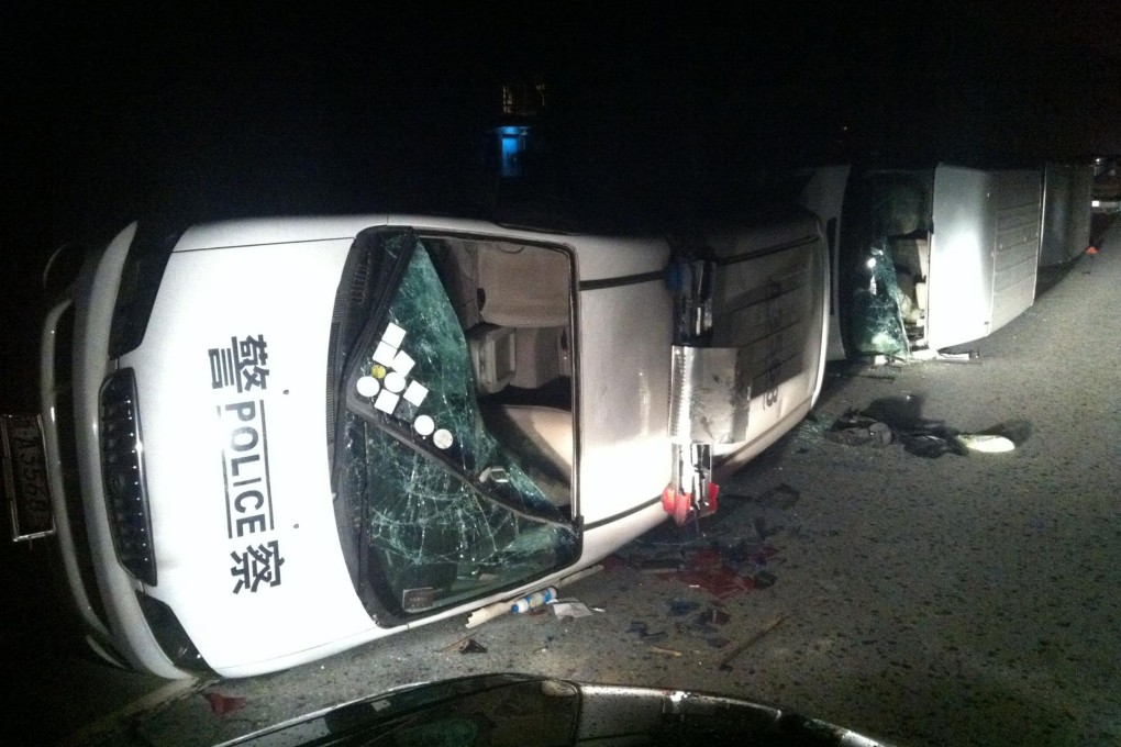 Police cars were among the damaged vehicles. Photo: AFP