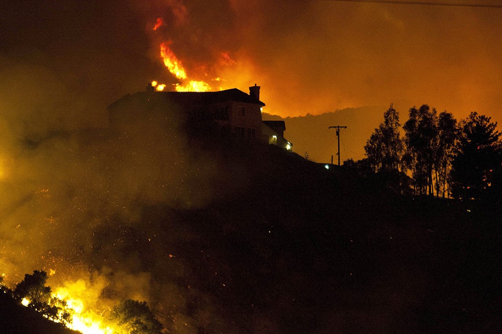 A wildfire threatens homes in San Marcos, California, on Thursday. Photo: AFP