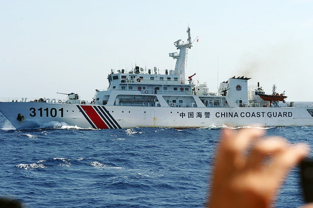 A Vietnamese coastguard officer monitors a Chinese coastguard vessel near China's oil drilling rig in disputed waters in the South China Sea. Photo: AFP