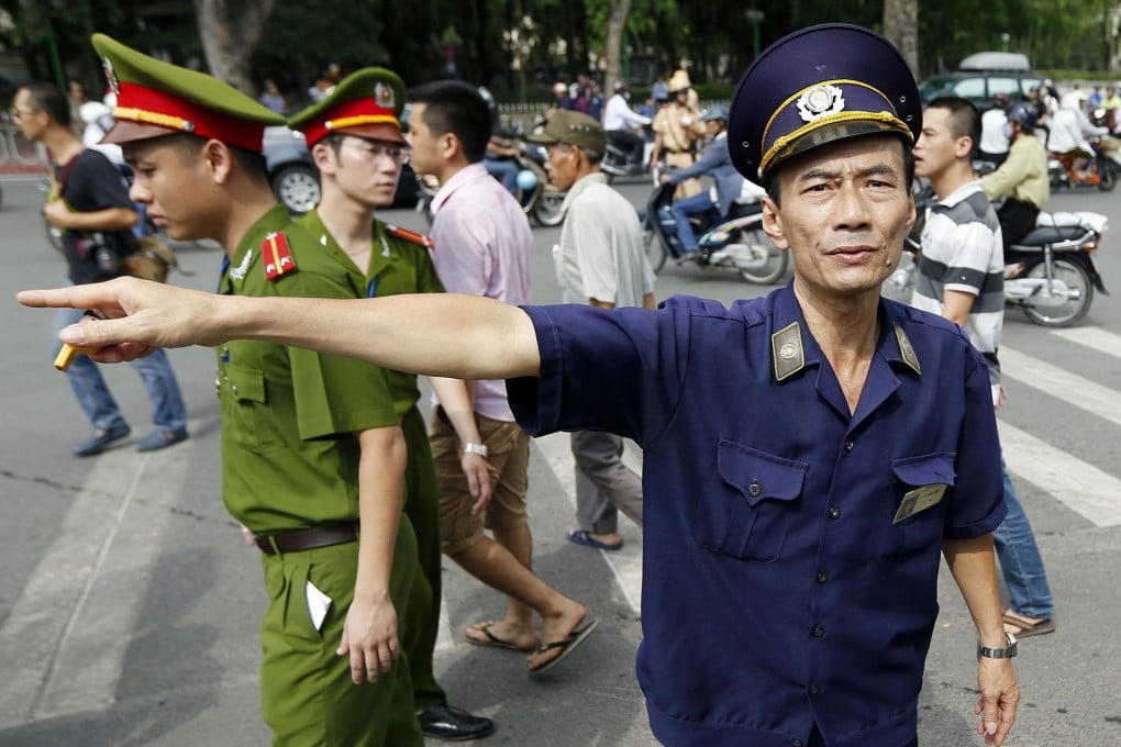 Police attempt to disperse protesters near the Chinese embassy in Hanoi yesterday. Streets in the capital and a park close to the embassy were closed. Photo: EPA