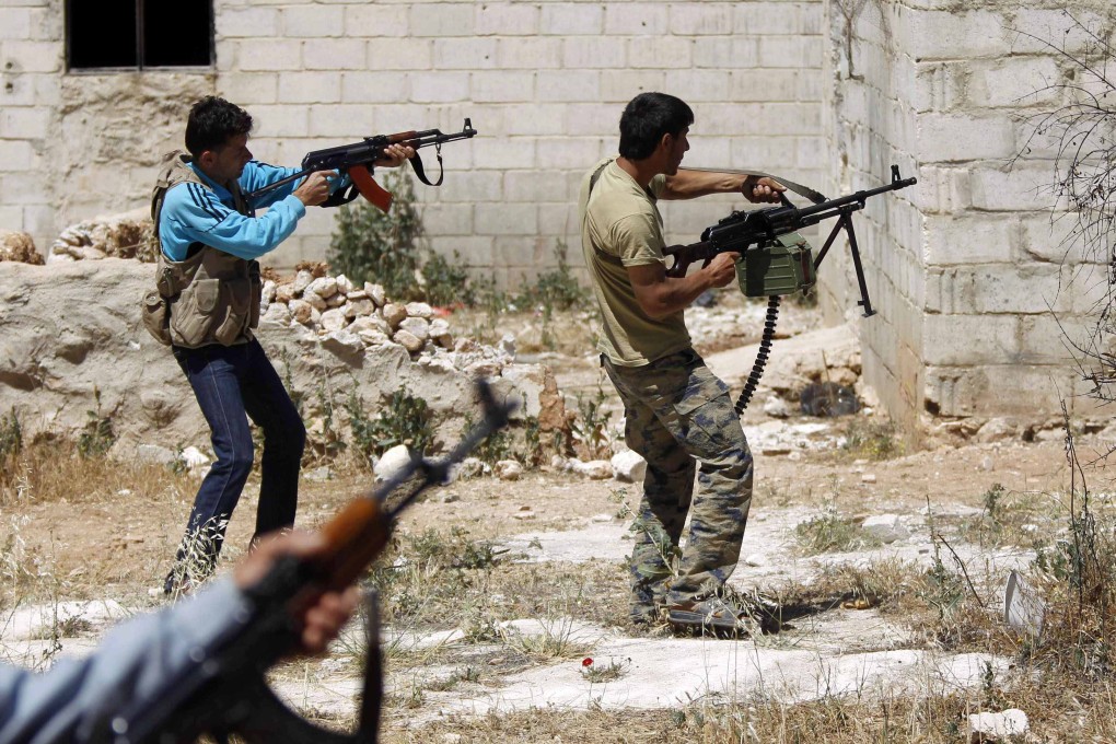 Free Syrian Army fighters. The chief of Syria’s air defence forces, General Hussein Isaac, has been killed in combat near Damascus. Photo: Reuters