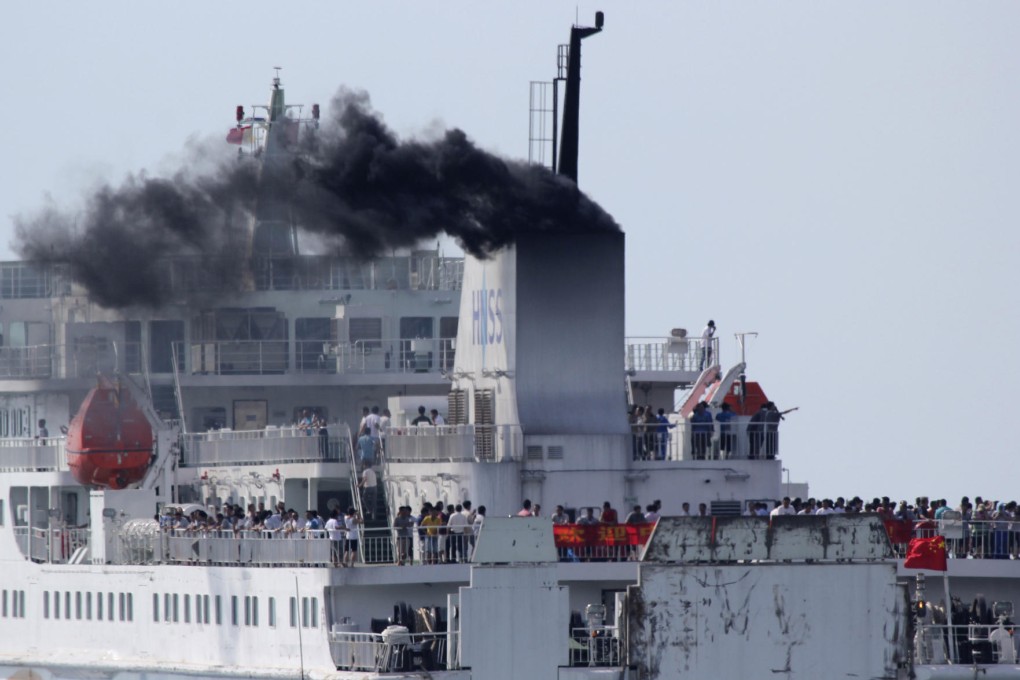 Chinese workers leave on a ship from Vung Ang port. Photo: AP